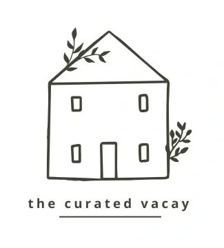 A black and white drawing of a house with the words " the curated vacay ".