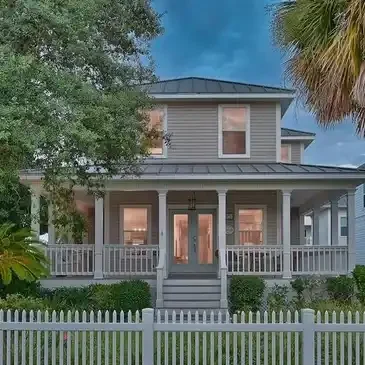 A large white house with a fence around it.